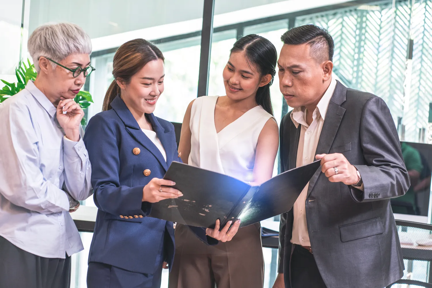 CMM - business consulting - Businessman with female management team and female employee holding documents discussing, checking accounts